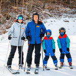 A family skiing at Massanutten Resort