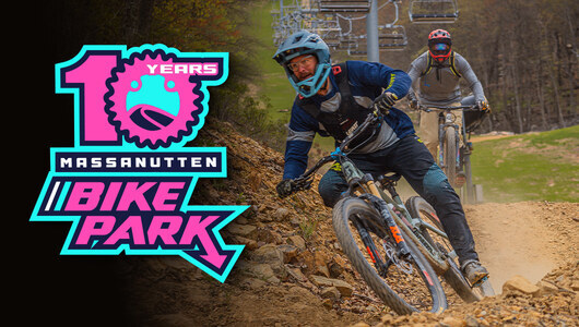 A guest riding a mountain bike and the MTB10 years logo