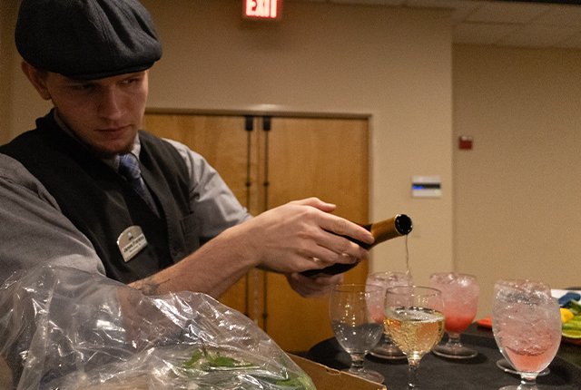 Employee pouring a glass